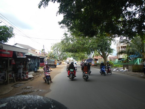 On the back of a motorcycle zipping through the streets